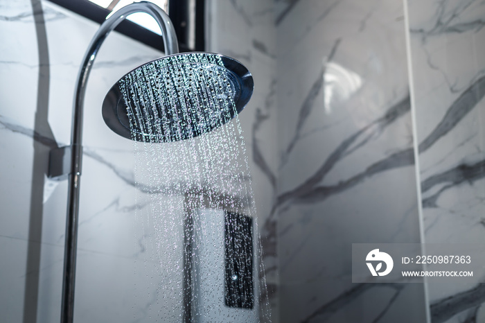 [shower head] shower head in bathroom with water drops flowing.