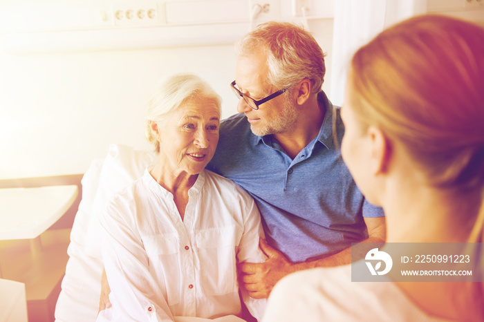 happy family visiting senior woman at hospital