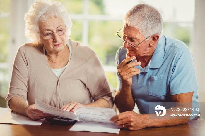 Senior couple counting bills