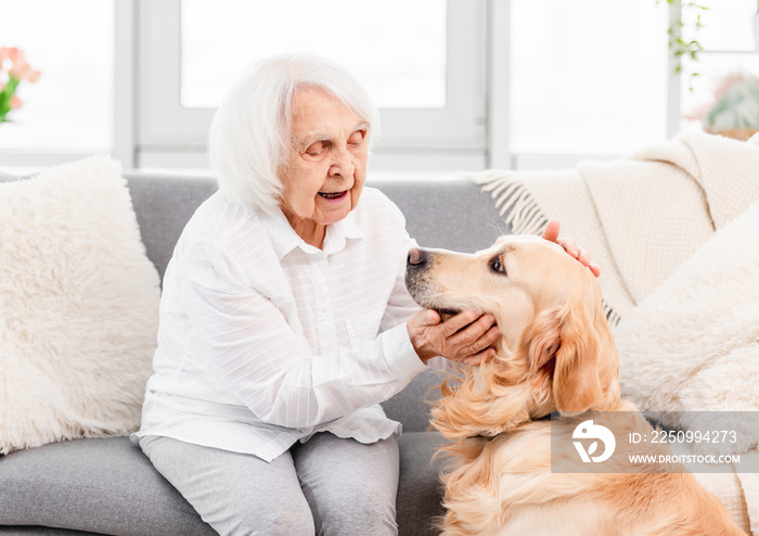 Eldery woman with golden retriever dog