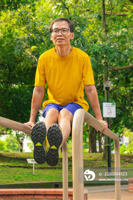 an elderly man doing his workout in a park early morning