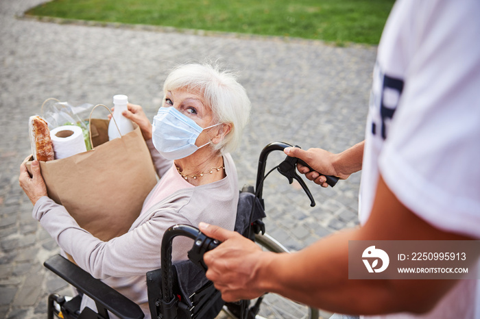 Curious lady looking at the person helping her during the pandemic