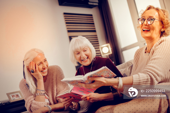 Joyful delighted woman spending time with her friends