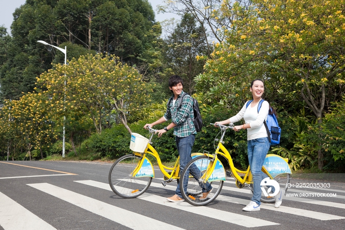 年轻大学生在校园里骑车