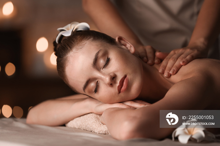 Young woman having massage in spa salon