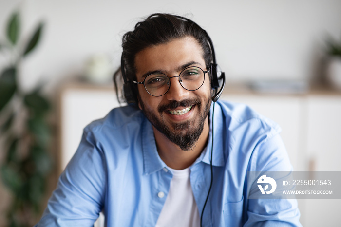 Call Center Operator. Closeup portrait of smiling indian man in headset