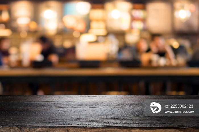 Wooden table with blur background of coffee shop.