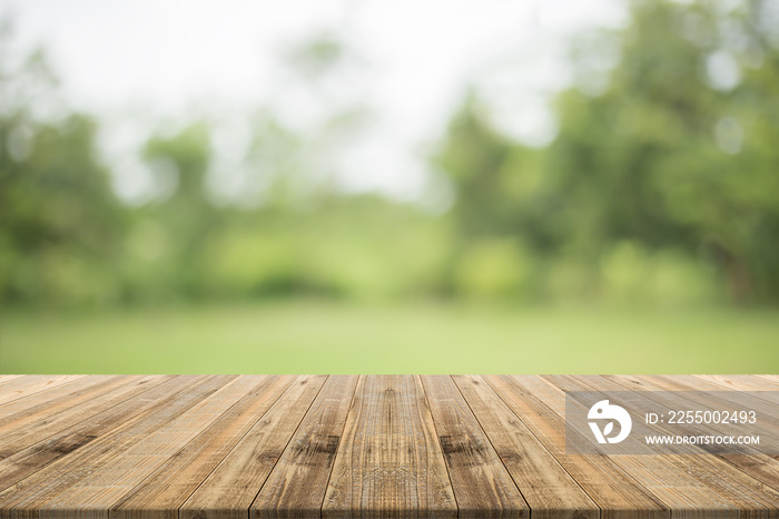 Wood table top on nature green blurred background,for montage your products