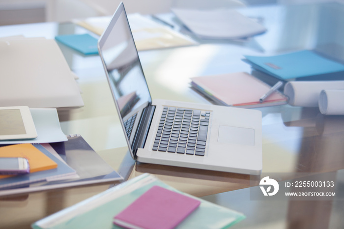 Laptop and paperwork on desk