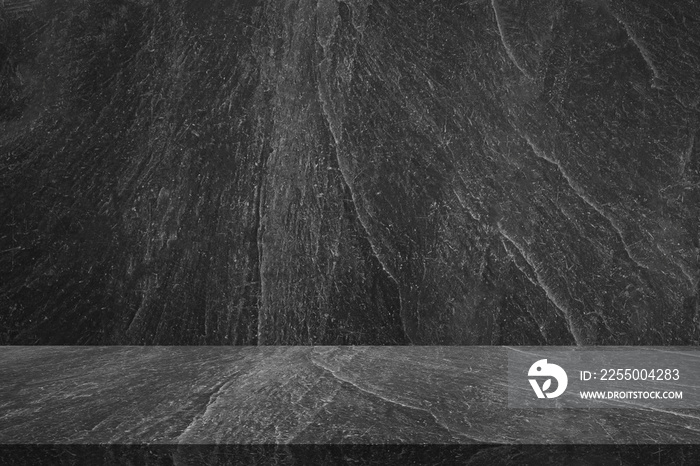 Empty black marble table top with black stone wall texture background