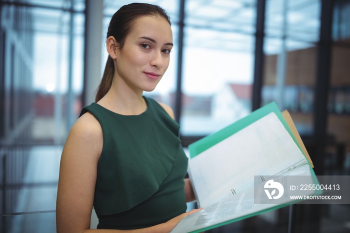 Businesswoman holding files at office