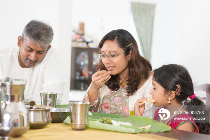 Indian family eating banana leaf rice