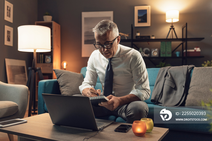 Businessman working from home at night