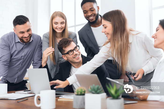 Startup team working on laptop at meeting