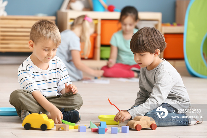 Cute little children playing in kindergarten