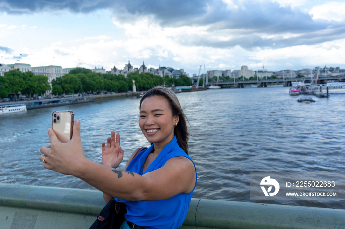 United Kingdom, London, Woman taking�selfie�with River Thames in background