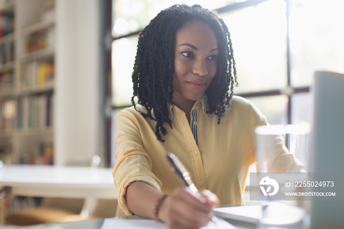 Young businesswoman working at laptop