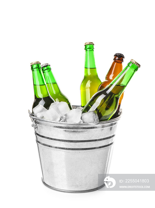 Bottles of beer in ice bucket on white background