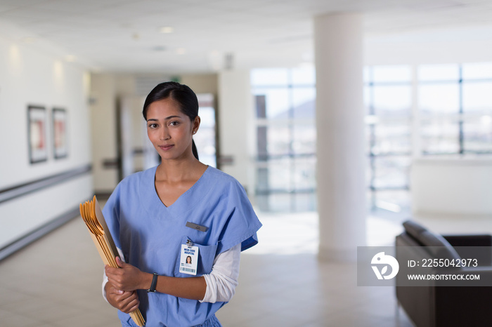 Portrait confident female nurse in hospital corridor