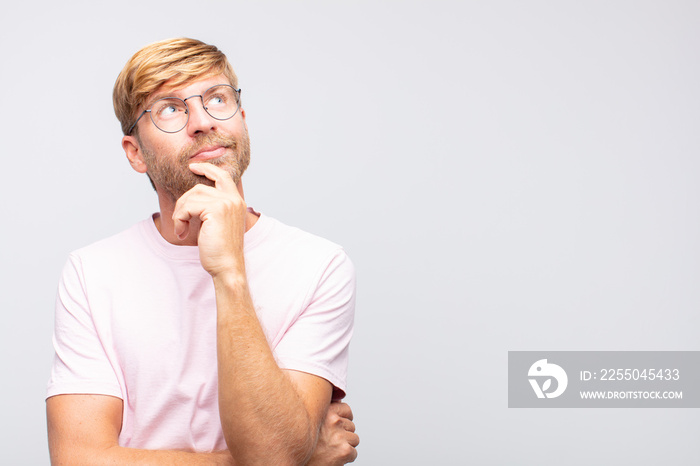 young blond man thinking  or doubting