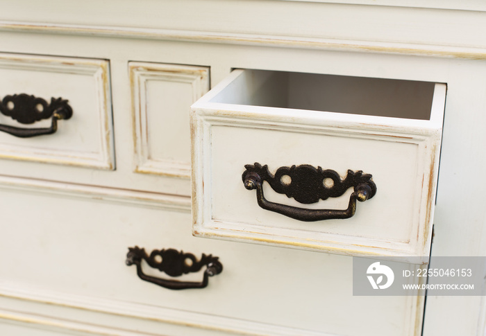 Vintage wooden chest of drawers with black metal handles open