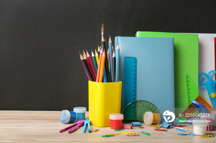 Set of school supplies on table in classroom