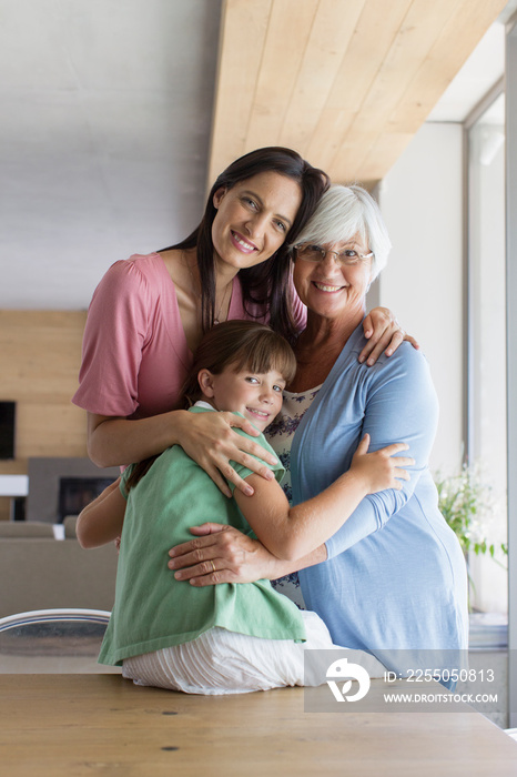 Portrait happy multi-generation women hugging