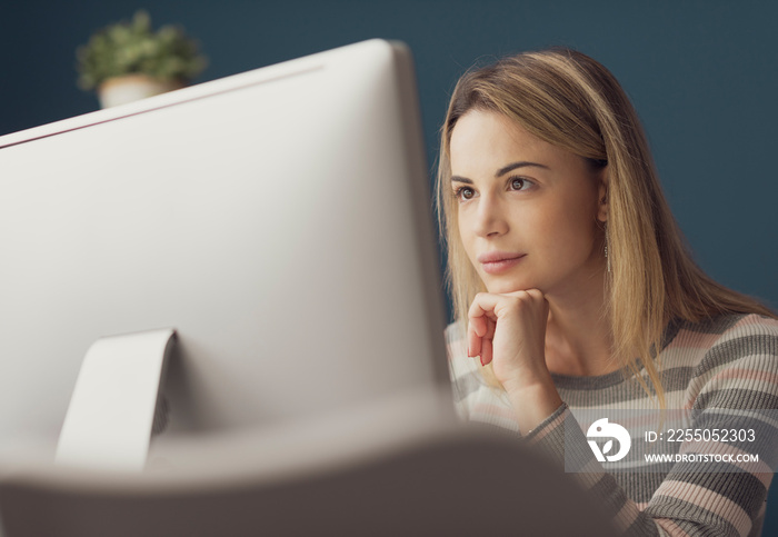 Young attractive woman working with a computer