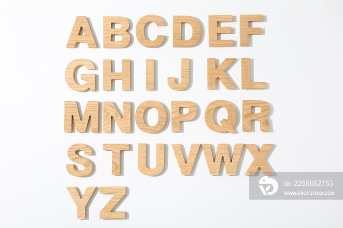 Wooden letters of English alphabet on white background, top view