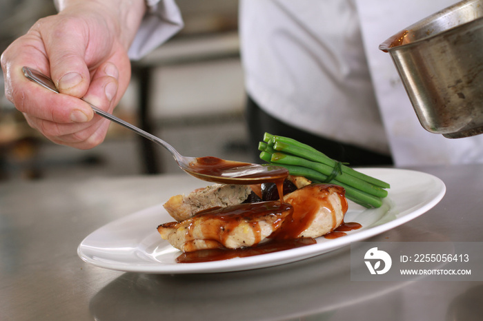 chef plating chicken dinner