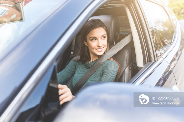 Young woman driving a car in the city