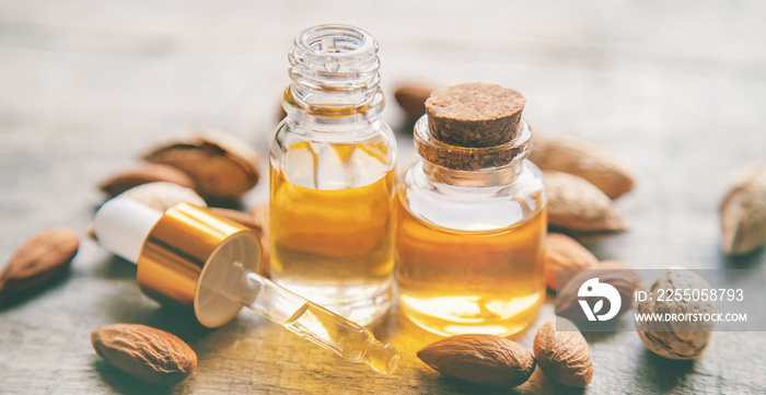 Almond essential oil in a small bottle. Selective focus.