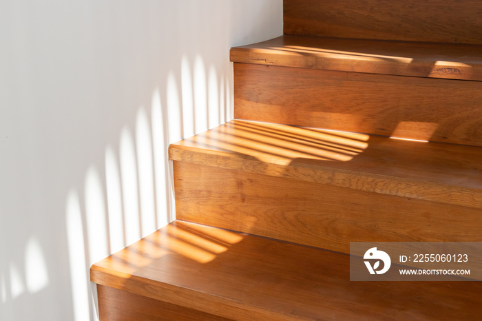 light and shadow on wooden stair steps.