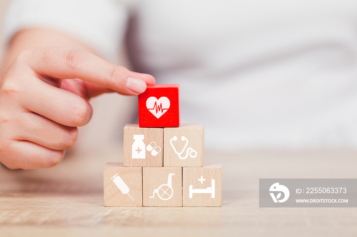 Health Insurance Concept,hand arranging wood block stacking with icon healthcare medical.