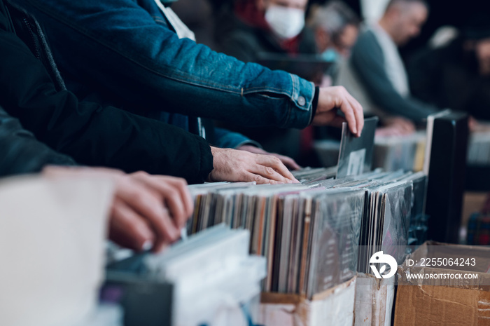 Man hands browsing vinyl album in a record store