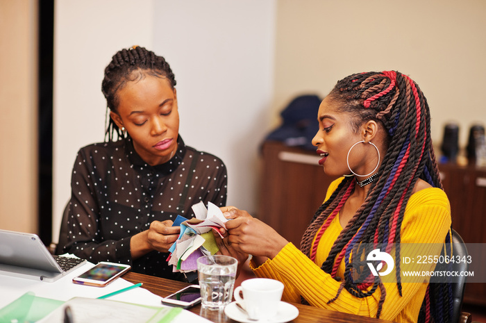 African american women colleagues, crew of divercity female partners in office sit at the table and 