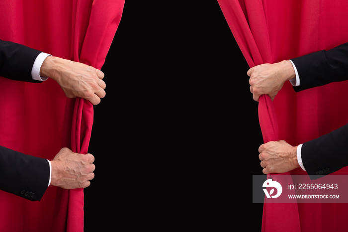 Two Men Opening Red Curtain