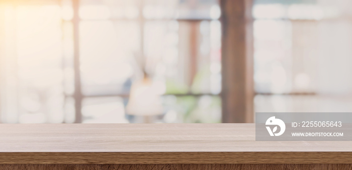 Wooden table top with blurred people in coffee shop and cafe background for display montage, copy sp