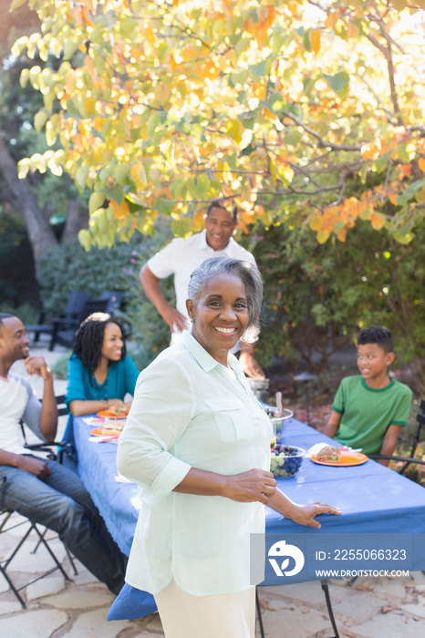 Portrait happy senior woman enjoying lunch with family on autumn patio