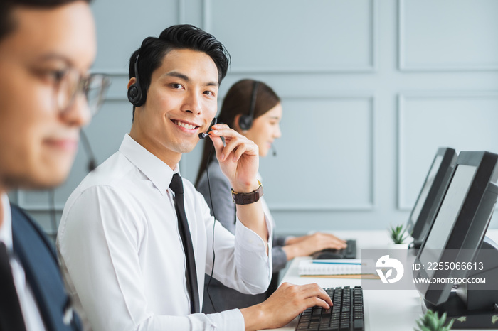 Asian call center team, customer service, telesales in formal suit wearing headset or headphone talk