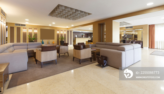 Gray sofas and armchairs in hotel lounge room