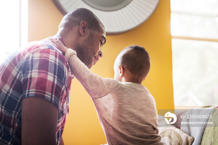 Father and son sitting at home