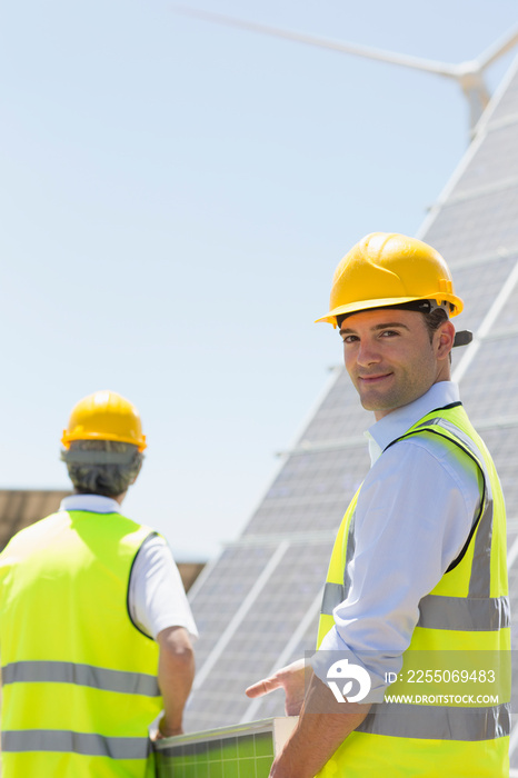 Portrait confident male engineer working on solar farm