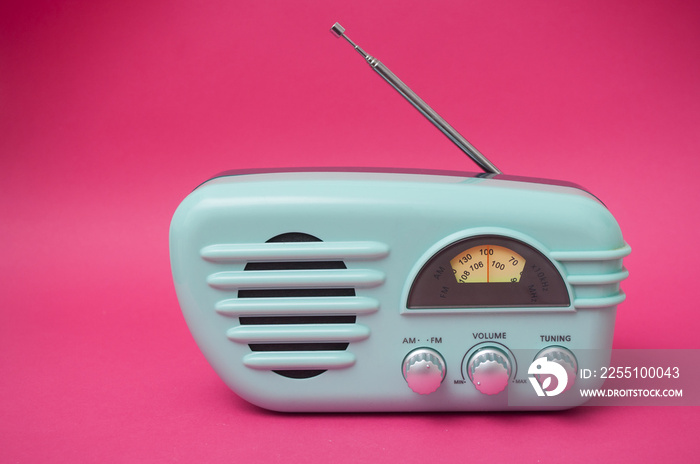 closeup of vintage fifties style radio on pink background