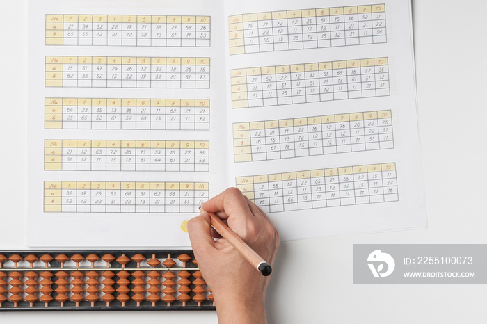 Doing mental math or mental arithmetic. Hand of person using abacus for calculating. Learning to use abacus on mental math courses