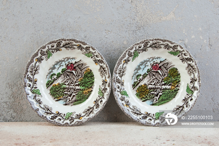 Two antique porcelain bowls on concrete