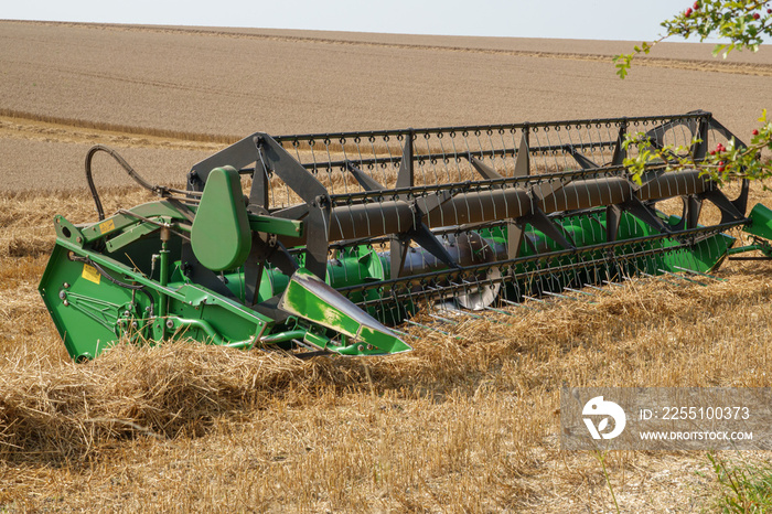 John Deere 24’ harvester equipment awaiting the replacement combine on Salisbury Plain Wiltshire UK