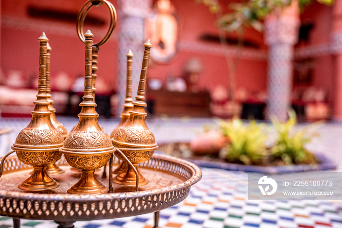 Close up of decorative ancient metal oil lamp with ring on table