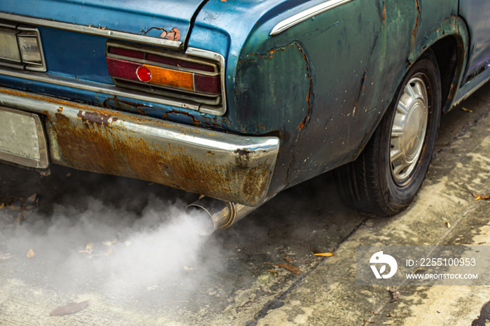 Vintage old car emits pollutant out of the exhaust