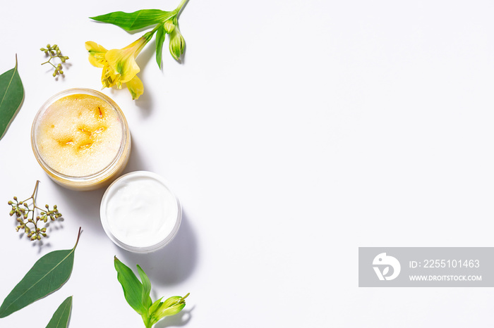 Set of natural herbal cosmetic on white background with flowers and leaves.